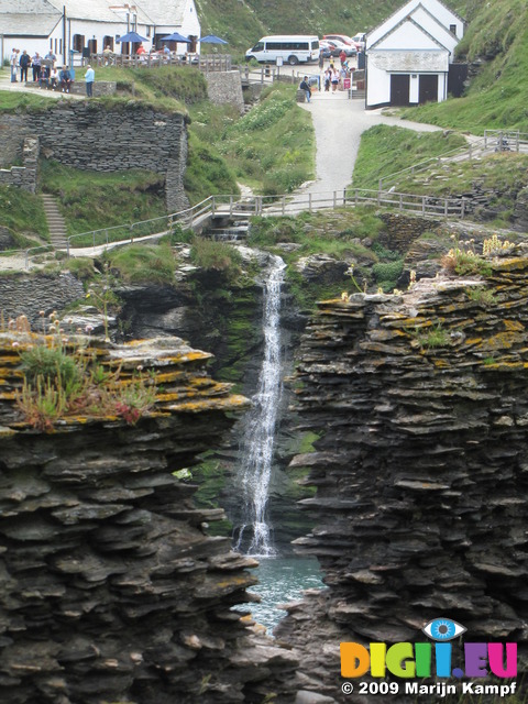 SX07260 Waterfall framed by Tintagel Castle medieval wall